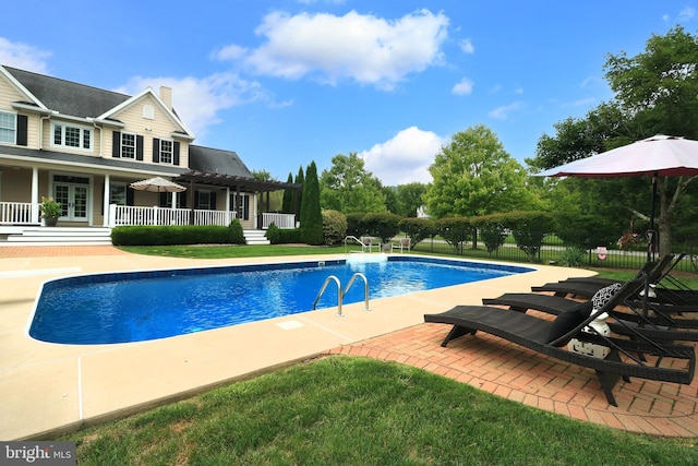 view of pool with a pergola, a yard, french doors, and a patio