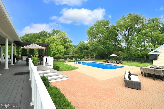 view of pool with a deck and a patio area