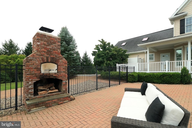 view of patio featuring an outdoor living space with a fireplace