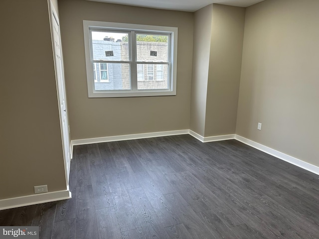 spare room with dark wood-type flooring