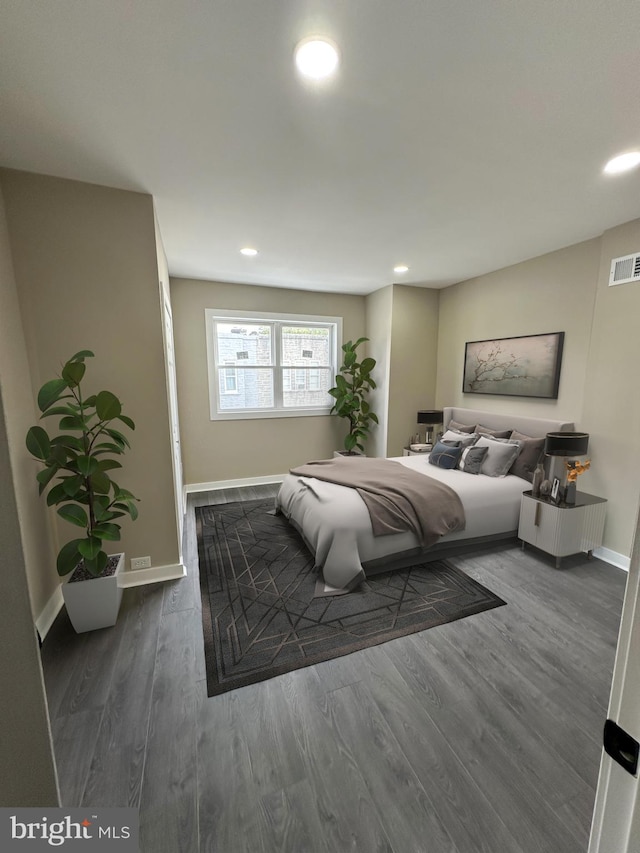 bedroom with dark hardwood / wood-style floors