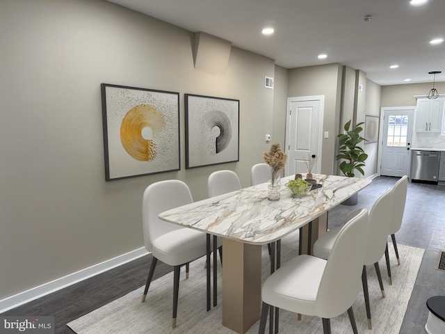 dining space with dark hardwood / wood-style floors