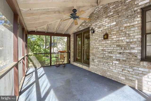 unfurnished sunroom with vaulted ceiling and ceiling fan