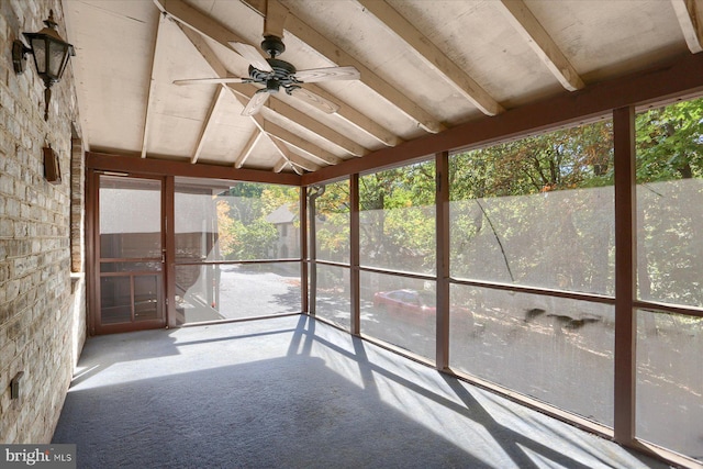 unfurnished sunroom featuring vaulted ceiling with beams and ceiling fan