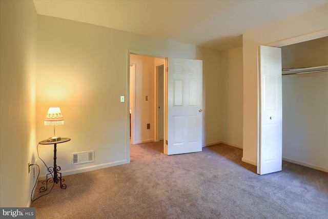 unfurnished bedroom featuring carpet floors and a closet