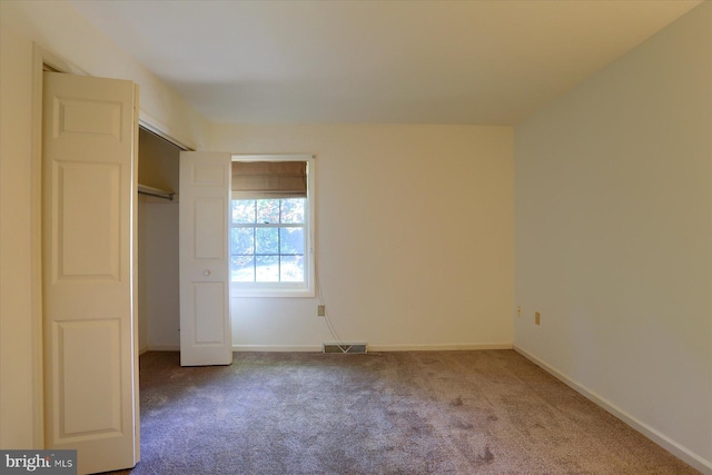 unfurnished bedroom with carpet and a closet