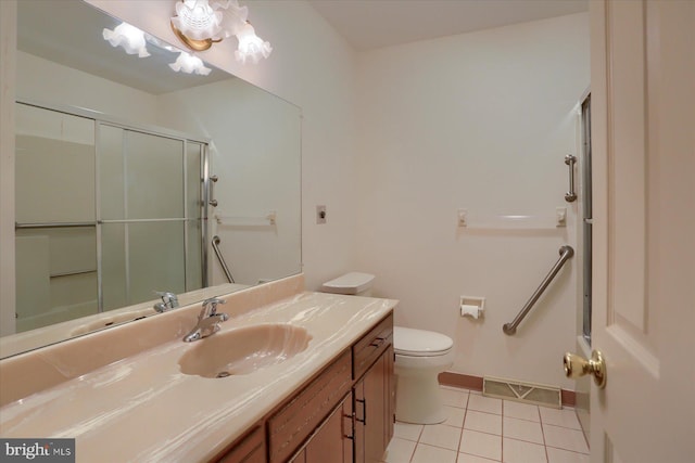 bathroom with toilet, walk in shower, vanity, and tile patterned floors