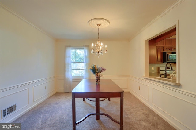 home office featuring crown molding, light colored carpet, and an inviting chandelier