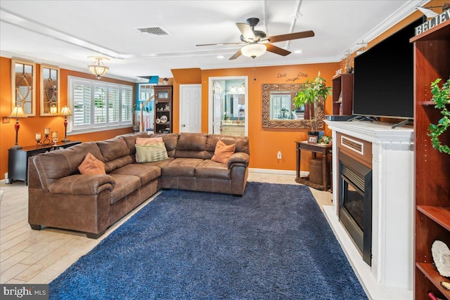 living room with light hardwood / wood-style flooring, ornamental molding, and ceiling fan