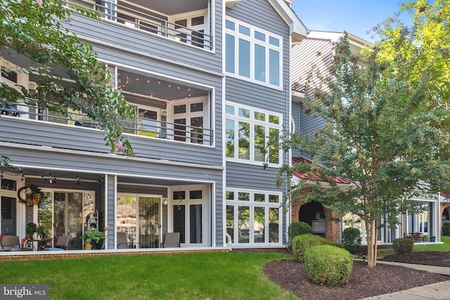 exterior space with a balcony and a yard