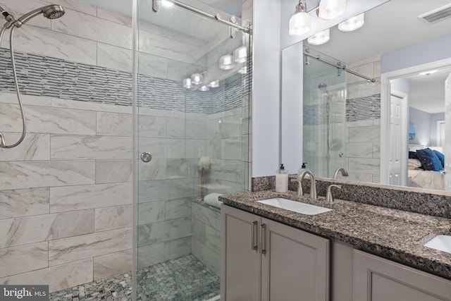 bathroom featuring walk in shower and vanity