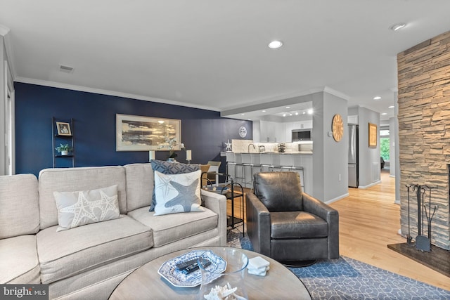 living room with crown molding and wood-type flooring