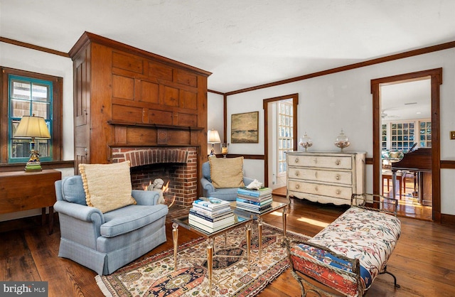 sitting room with crown molding, a fireplace, and dark hardwood / wood-style floors