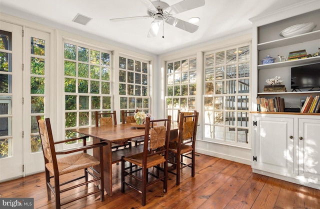 sunroom featuring ceiling fan