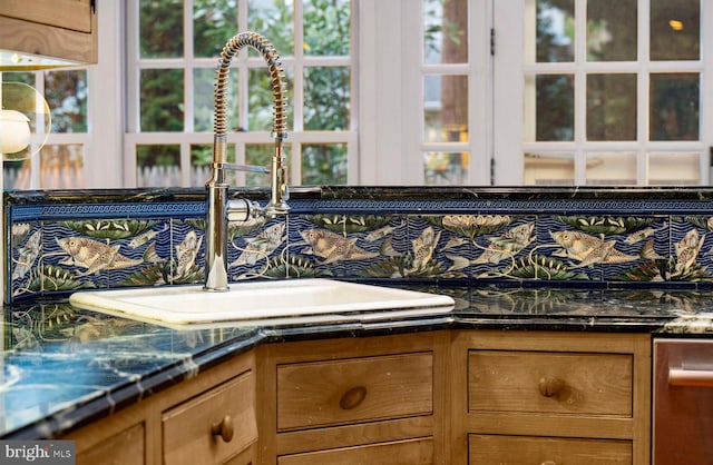 details featuring tasteful backsplash and sink