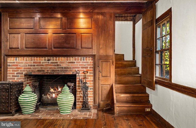 interior space featuring wood-type flooring and a brick fireplace