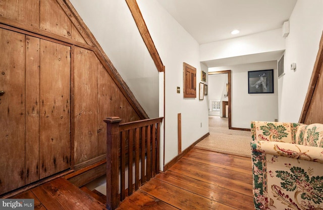 staircase with hardwood / wood-style flooring