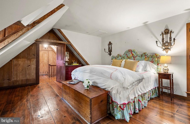 bedroom with vaulted ceiling and dark hardwood / wood-style floors