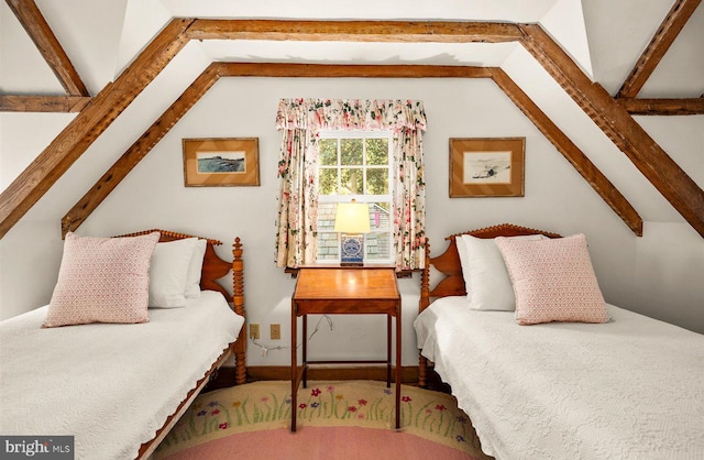 bedroom with vaulted ceiling with beams