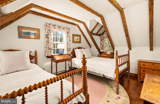 bedroom with lofted ceiling with beams and hardwood / wood-style flooring