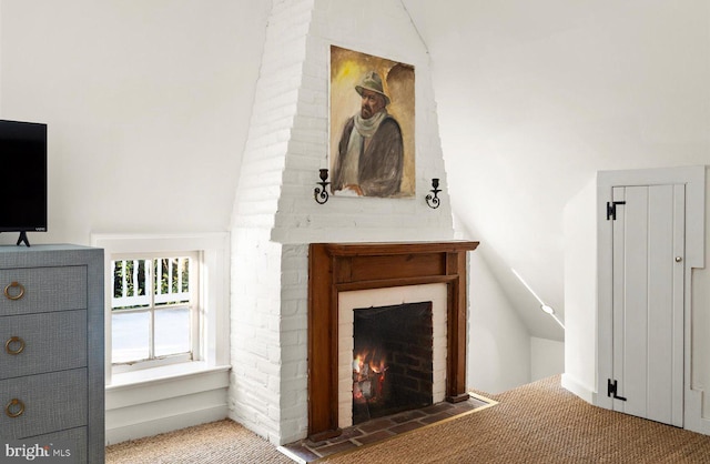 unfurnished living room with carpet floors and vaulted ceiling