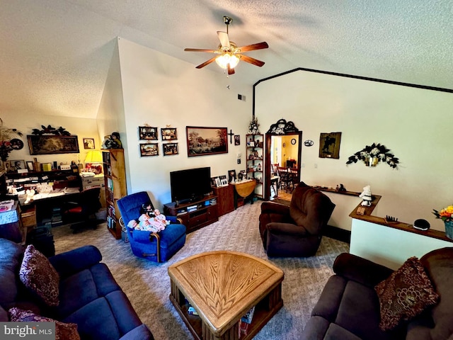 living room with ceiling fan, a textured ceiling, lofted ceiling, and carpet