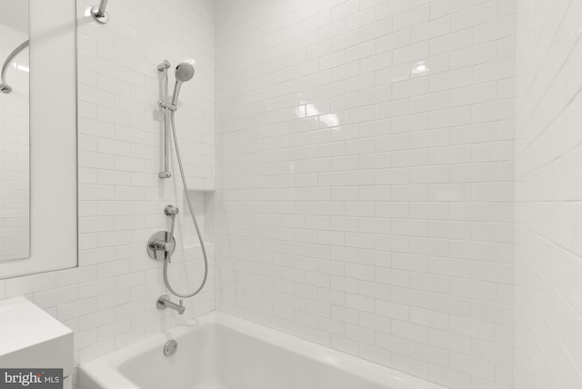 bathroom featuring vanity and tiled shower / bath combo