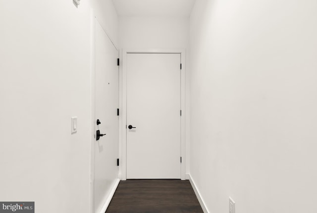 corridor featuring dark hardwood / wood-style flooring