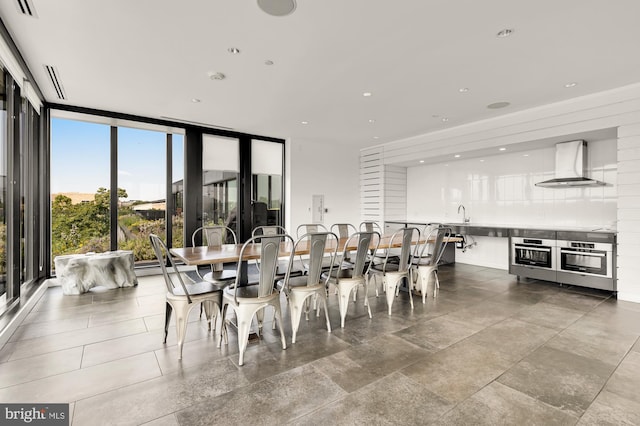 dining area featuring expansive windows and sink