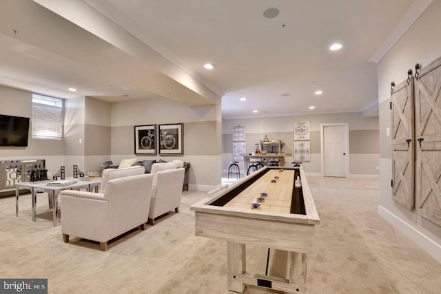 recreation room with a barn door, light carpet, and crown molding