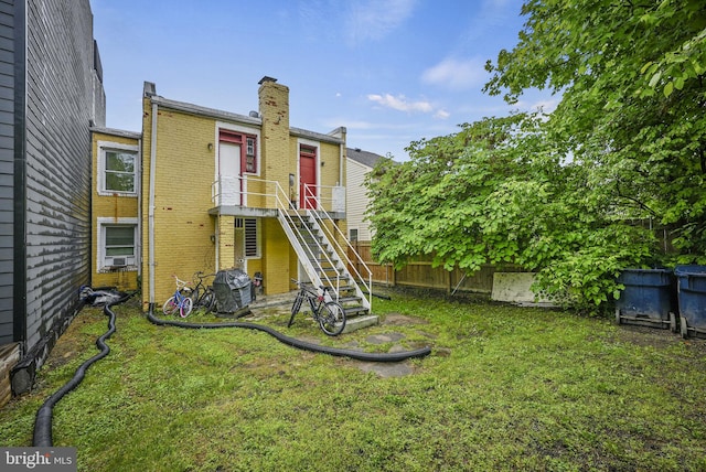 rear view of property with a yard