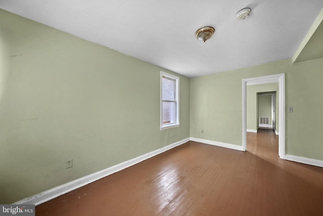 spare room with hardwood / wood-style floors