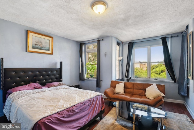 bedroom with hardwood / wood-style flooring and a textured ceiling