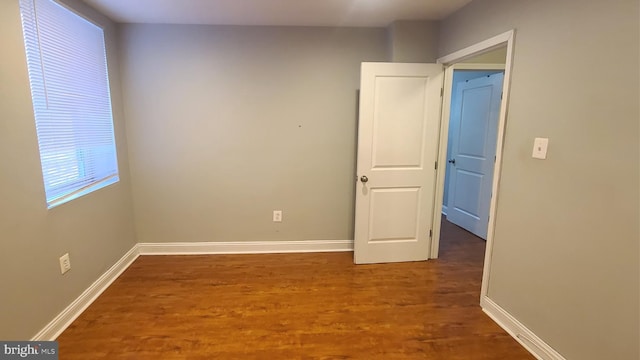 spare room with dark hardwood / wood-style floors