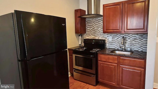 kitchen with sink, wall chimney exhaust hood, stainless steel electric stove, decorative backsplash, and black refrigerator