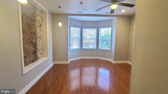 unfurnished room featuring dark hardwood / wood-style floors and ceiling fan