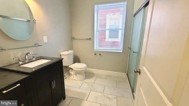 bathroom with tile patterned floors, vanity, toilet, and walk in shower