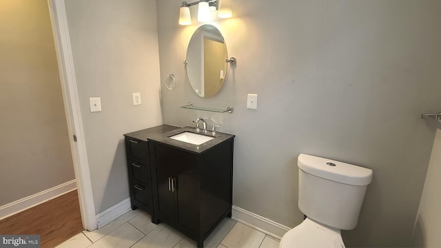 bathroom featuring tile patterned flooring, vanity, and toilet