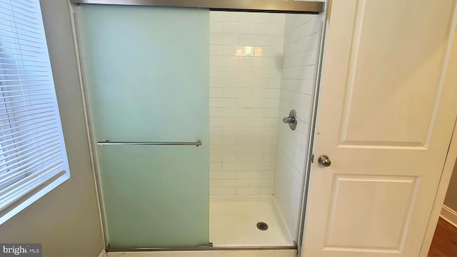 bathroom with a shower with shower door