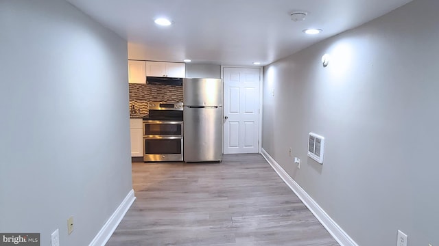 hallway with light wood-type flooring