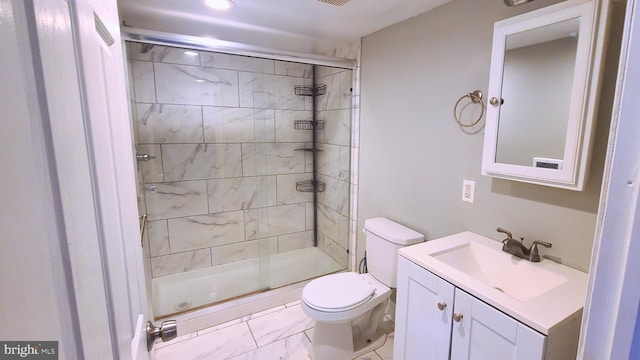 bathroom featuring vanity, toilet, and a shower with shower door