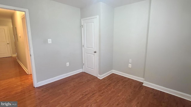 spare room featuring dark wood-type flooring