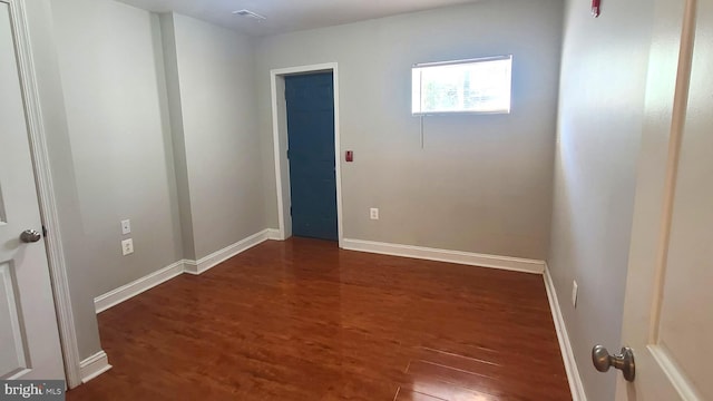 empty room featuring dark wood-type flooring