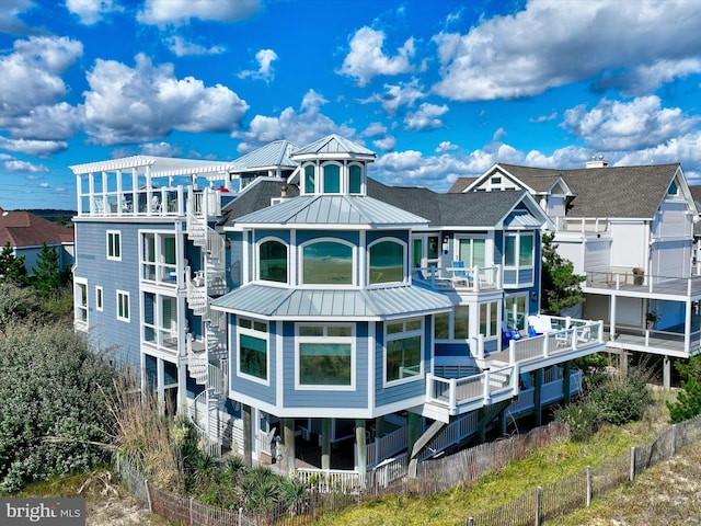 40110 Owens Ct, Fenwick Island, DE 19944 - back of property featuring a standing seam roof, metal roof, and fence