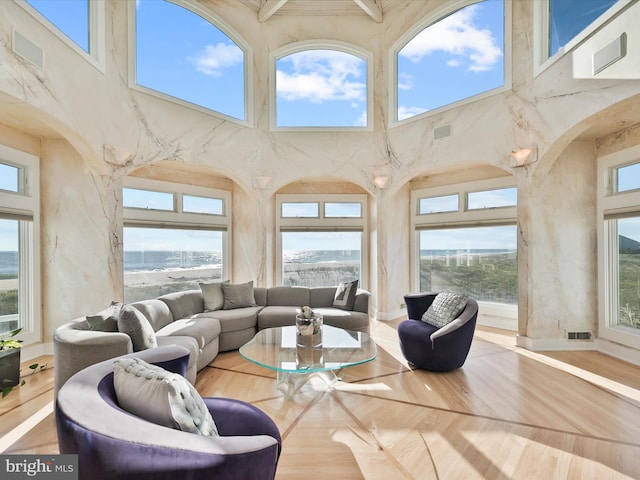 living room featuring a high ceiling and plenty of natural light