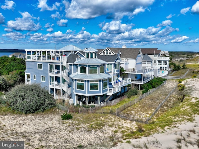 back of house featuring a water view and a balcony