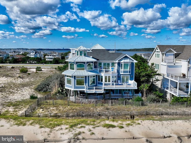 back of property with a balcony