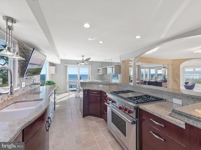 40110 Owens Ct, Fenwick Island, DE 19944 - kitchen featuring recessed lighting, light stone countertops, luxury stove, ornate columns, and a sink