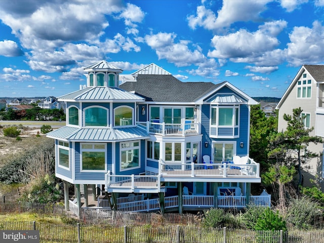 40110 Owens Ct, Fenwick Island, DE 19944 - back of house featuring metal roof, fence, and a balcony