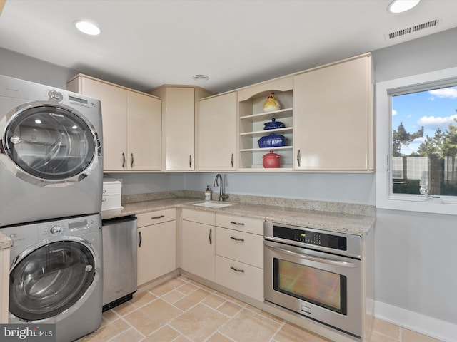 40110 Owens Ct, Fenwick Island, DE 19944 - laundry area featuring visible vents, a sink, stacked washing maching and dryer, laundry area, and recessed lighting